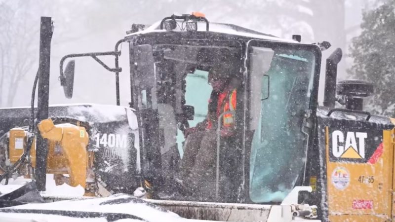 LA County heavy equipment is used to clear roads during a winter snow storm.