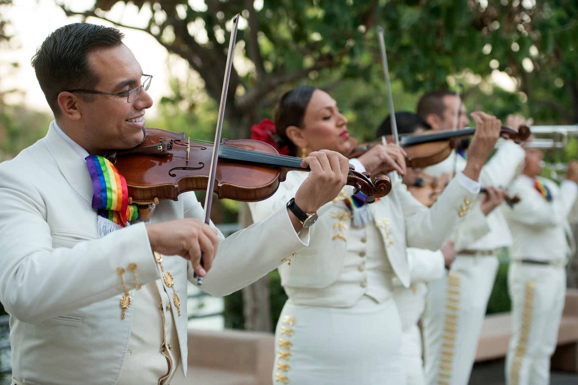 A Mariachi band plays for a group of spectators.