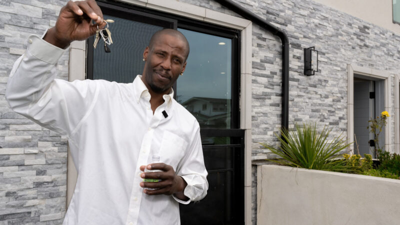 Bruce Hogans, who experienced homelessness for 20 years, holds the keys to his new apartment at The Dalton.