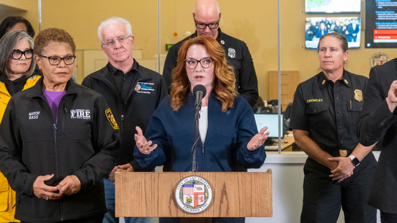 LA County Board of Supervisors Chair Lindsey P. Horvath speaks at a podium during a press conference on storm preparation.