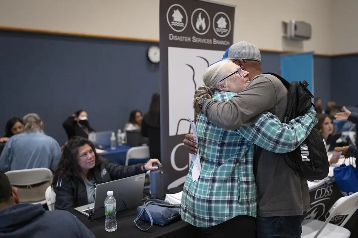 Two people hugging at an emergency event