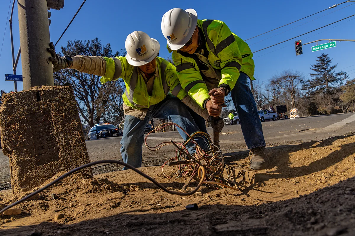 Twp public works employees, working on a street-light