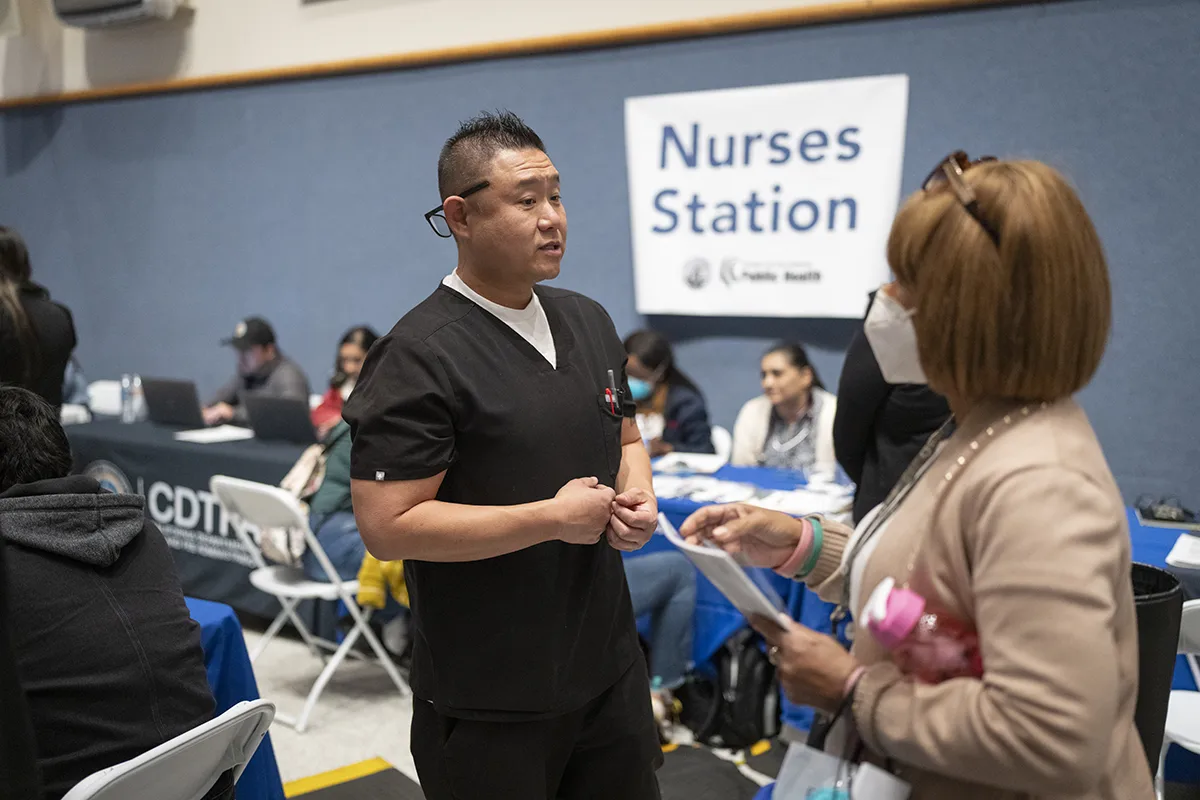 A medical professional at an emergency event, talking to another person